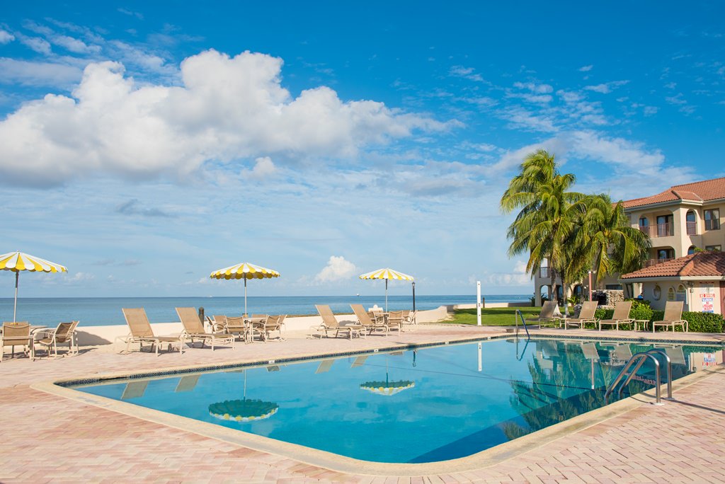 Georgetown Villas pool with ocean view behind it